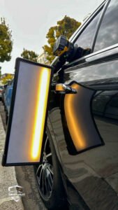 Dent Removal West London – After the dent was removed from a black car door in West London, PDR light showing a smooth panel.